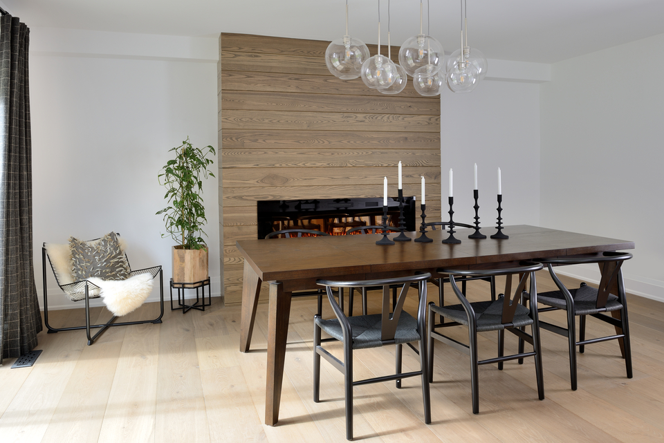 Minimalist dining room with wood floors and large rectangular dining table