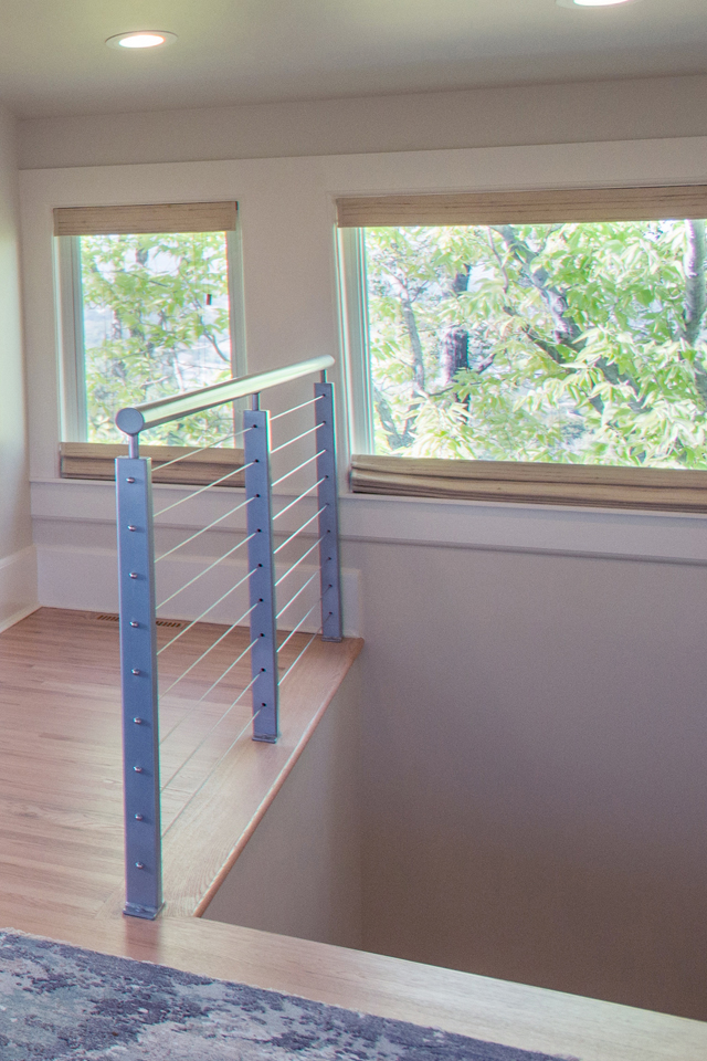 Remodeled staircase with large windows and recessed lighting
