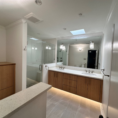 bathroom, wood cabinets, white countertops, glass shower