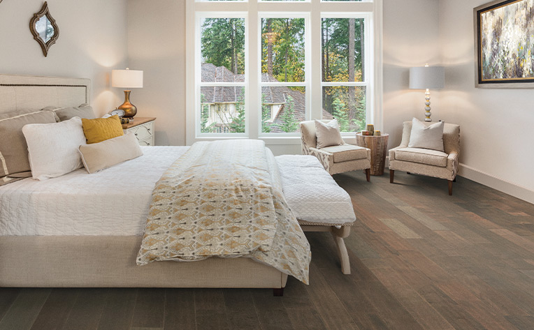 brown toned hardwood flooring in cozy bedroom